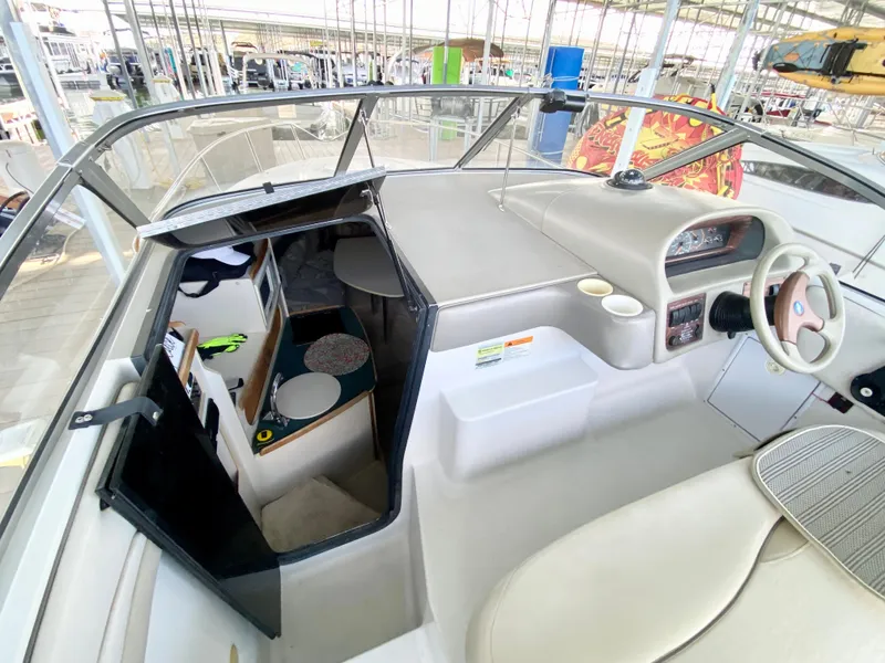 Slide: The Image of 1999 Four Winns 258 Vista boat interior with helm and cabin view. - 8