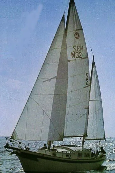 Slide: The Image of 1972 Fairweather Mariner 32 sailboat on open water, sails fully unfurled. - 11