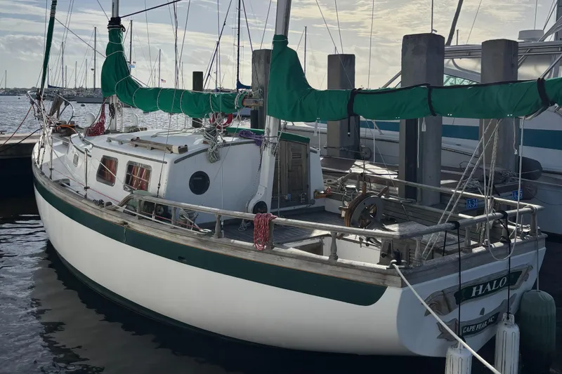 Slide: The Image of 1972 Fairweather Mariner 32 sailboat docked at marina with green sail covers. - 5