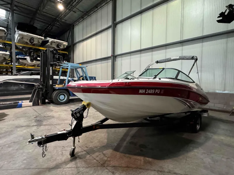 Slide: The Image of 2015 Yamaha SX190 boat in storage facility, red and white, on trailer. - 4