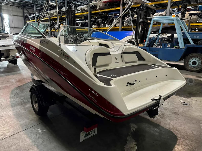 Slide: The Image of 2015 Yamaha Boats SX190 in warehouse, red and white, rear view. - 5