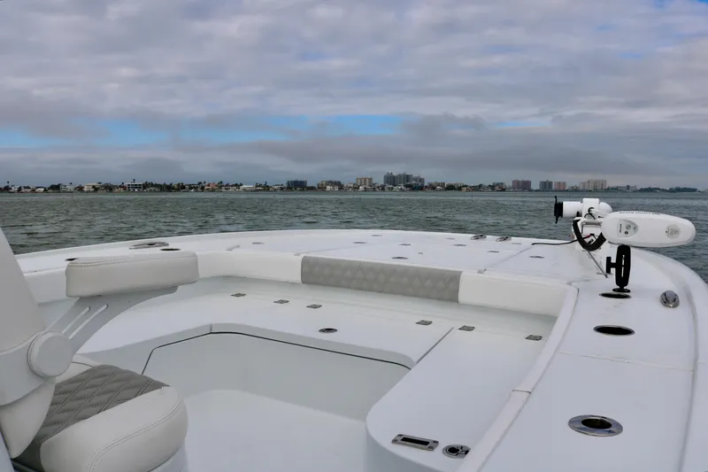 Slide: The Image of Freeman 28 boat deck, 2023 model, on calm waters with cloudy sky. - 14