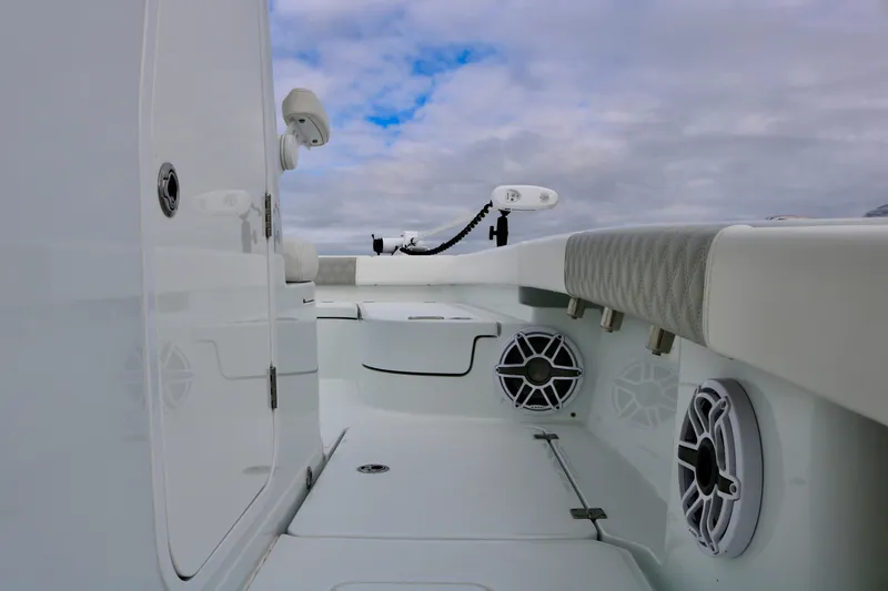 Slide: The Image of Freeman 28 boat interior, 2023 model, featuring speakers and sleek design under cloudy sky. - 17