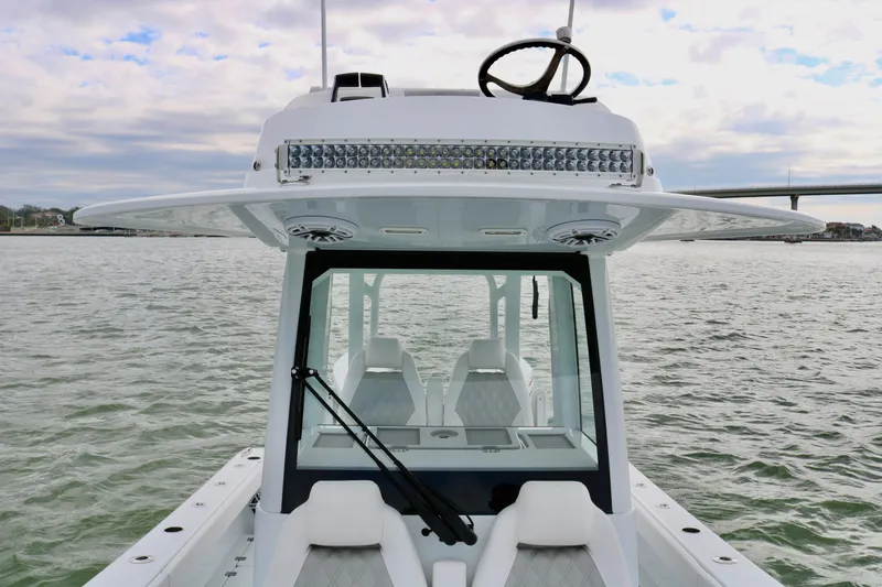 Slide: The Image of 2023 Freeman 28 boat on water, featuring modern design and spacious seating. - 20