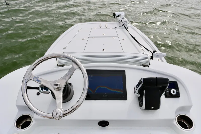 Slide: The Image of Freeman 28 boat dashboard with steering wheel and navigation screen, 2023 model. - 21