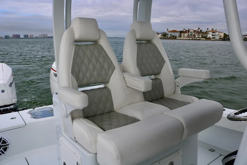 Slide: The Image of Luxury seating on 2023 Freeman 28 boat with quilted upholstery, ocean view. - 24