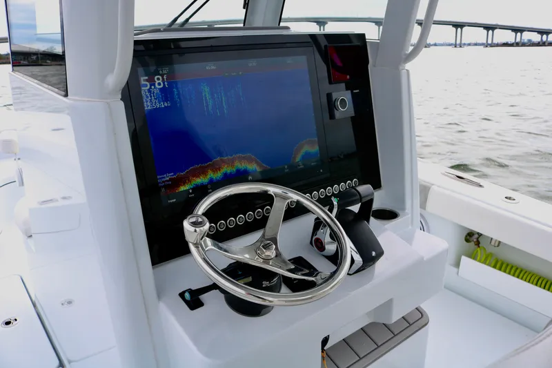 Slide: The Image of Freeman 28 boat dashboard with steering wheel and navigation display, 2023 model. - 25