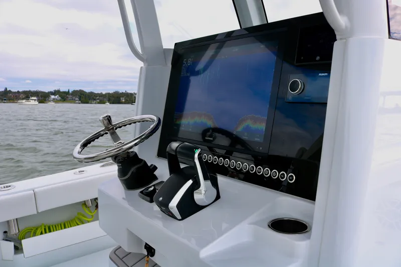 Slide: The Image of Freeman 28 boat dashboard with steering wheel and navigation screen, 2023 model. - 27