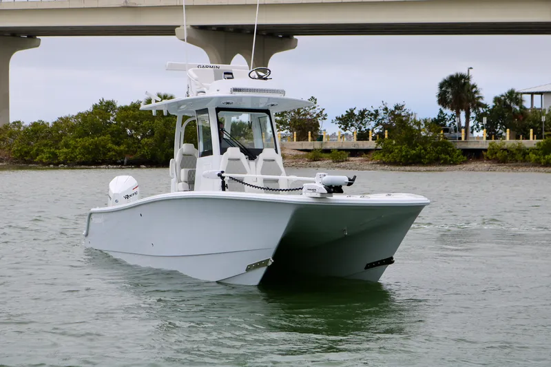 Slide: The Image of 2023 Freeman 28 boat on water near a bridge and trees. - 6