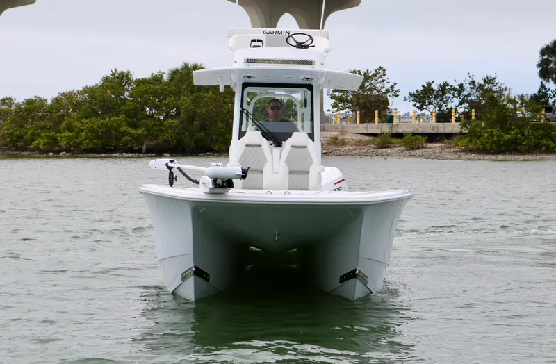 Slide: The Image of 2023 Freeman 28 boat on water, front view, with trees in background. - 8