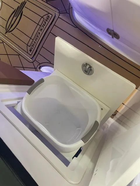 Slide: The Image of 2025 Chaparral 287 SSX boat sink with modern design and wood flooring. - 13