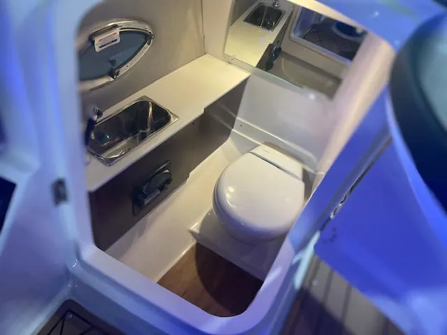 Slide: The Image of 2025 Chaparral 287 SSX boat interior bathroom with sink and toilet. - 14