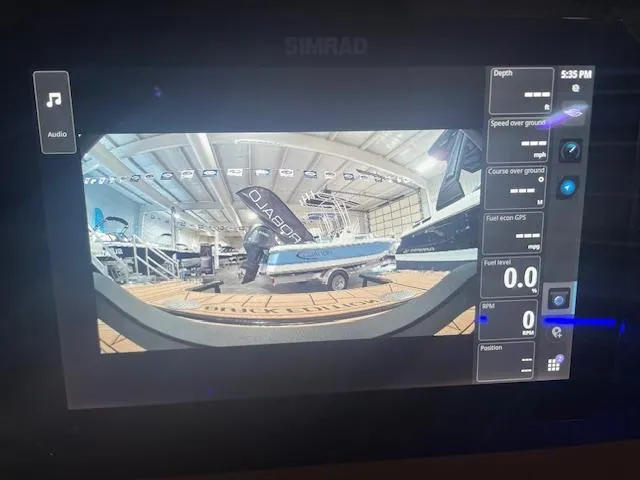 Slide: The Image of Simrad display showing 2025 Chaparral 287 SSX boat in a showroom. - 16