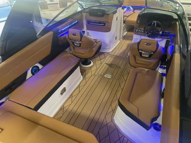 Slide: The Image of Luxurious interior of 2025 Chaparral 287 SSX boat with tan seating and modern dashboard. - 6