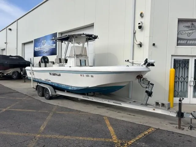 Slide: The Image of 2010 Carolina Skiff 25 Elite SS boat on trailer outside a marine service center. - 3