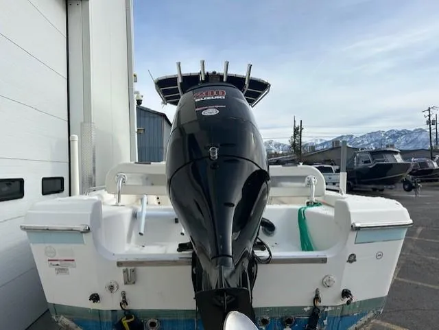 Slide: The Image of 2010 Carolina Skiff 25 Elite SS boat with powerful outboard motor, parked outdoors. - 6