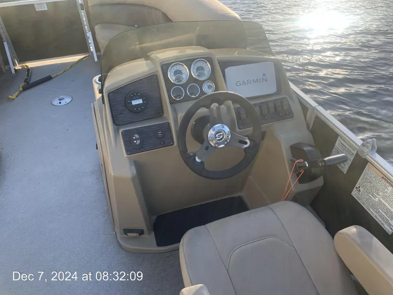 Slide: The Image of 2021 Sylvan Mirage 8522 LZ pontoon boat with beige seating, docked by a calm lake. - 19