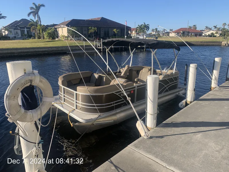 Slide: The Image of 2021 Sylvan Mirage 8522 LZ pontoon boat docked by waterfront homes. - 9
