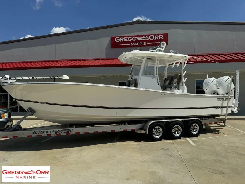 Slide: The Image of 2025 Regulator 30XO Crossover boat on trailer at Gregg Orr Marine dealership. - 1