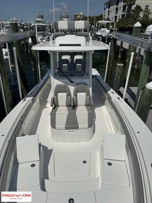 Slide: The Image of 2025 Regulator 30XO Crossover boat docked at marina, featuring sleek seating and modern design. - 11
