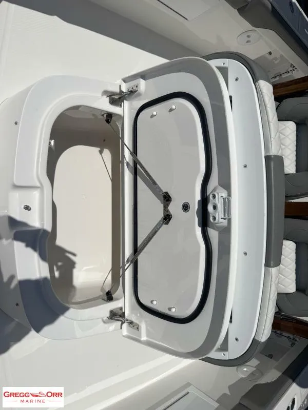 Slide: The Image of Open storage compartment on 2025 Regulator 30XO CROSSOVER boat deck. - 13