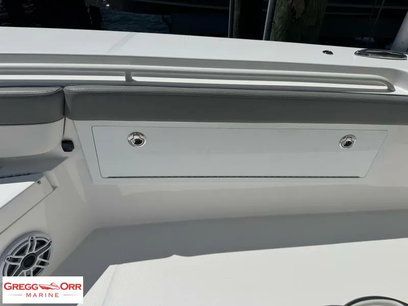 Slide: The Image of 2025 Regulator 30XO CROSSOVER boat interior with storage compartment and speaker. - 14
