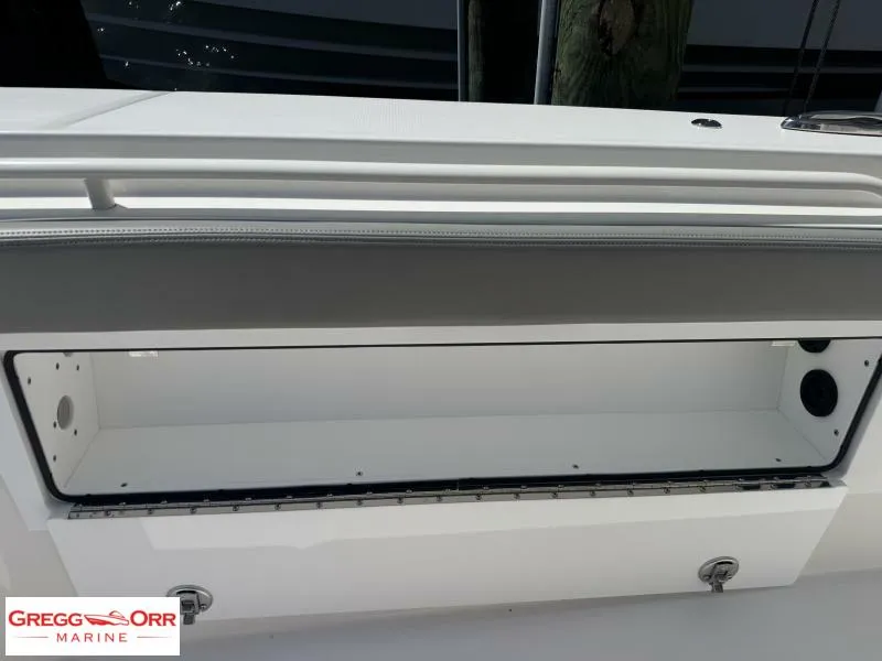 Slide: The Image of 2025 Regulator 30XO CROSSOVER boat storage compartment, open and empty, with sleek design. - 15