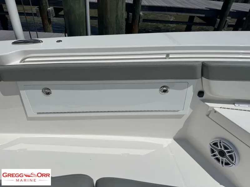 Slide: The Image of 2025 Regulator 30XO CROSSOVER boat interior with storage compartment and speaker. - 16