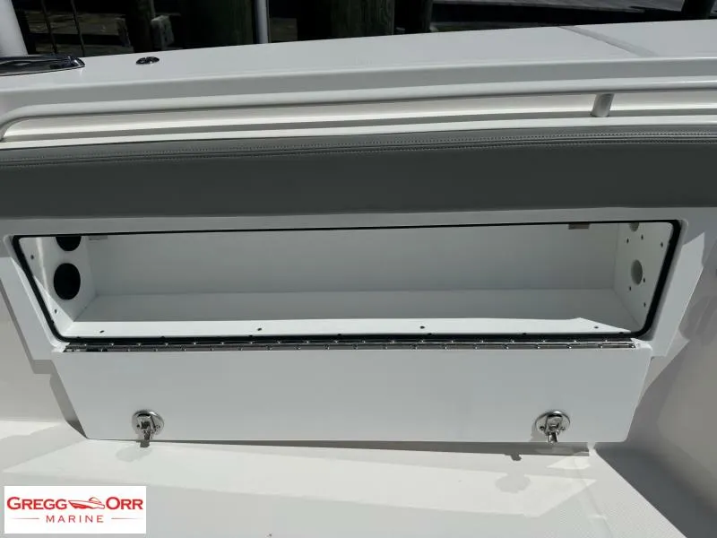Slide: The Image of 2025 Regulator 30XO CROSSOVER boat storage compartment, open with secure latches. - 17