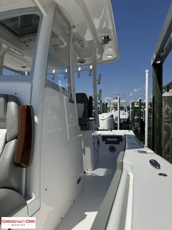 Slide: The Image of 2025 Regulator 30XO Crossover boat docked, showcasing sleek design and modern features. - 18