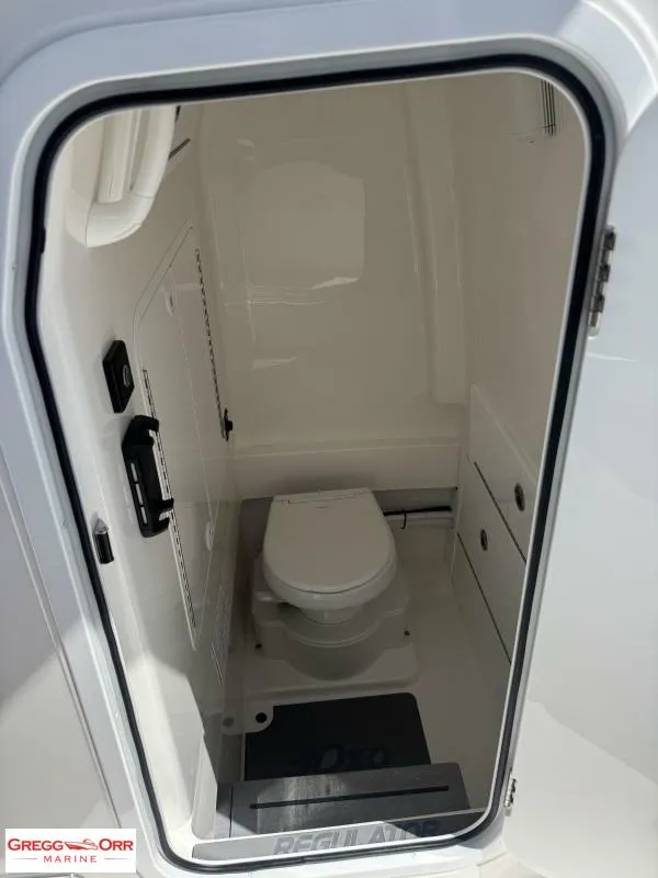 Slide: The Image of 2025 Regulator 30XO CROSSOVER boat interior with compact marine toilet. - 20