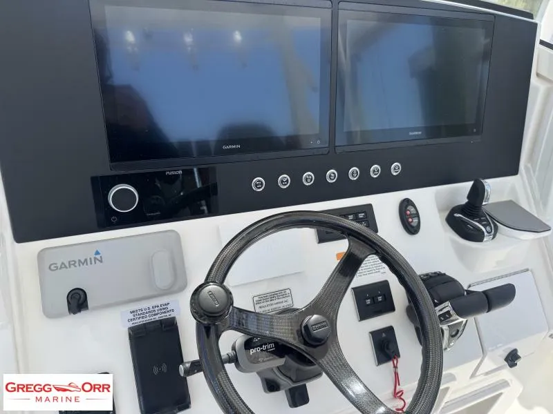 Slide: The Image of Control panel of 2025 Regulator 30XO CROSSOVER with Garmin displays and steering wheel. - 25