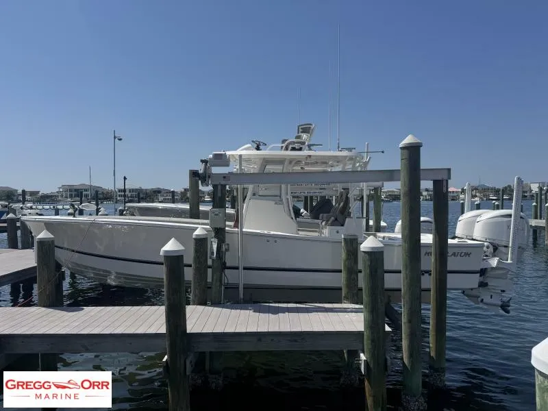 Slide: The Image of 2025 Regulator 30XO CROSSOVER boat docked at marina under clear blue sky. - 3