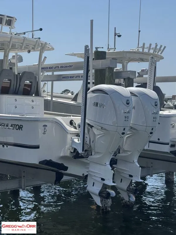 Slide: The Image of 2025 Regulator 30XO CROSSOVER boat with dual Yamaha outboard engines docked at marina. - 4