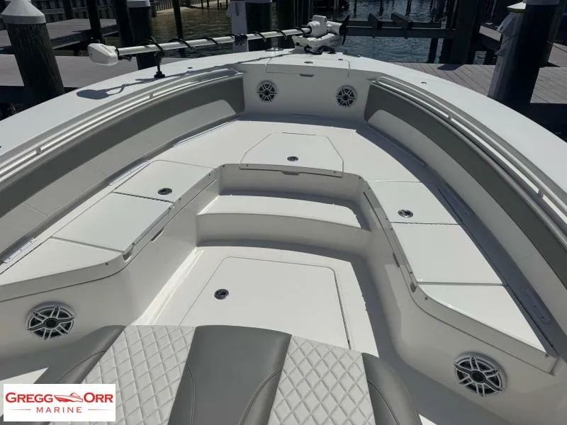 Slide: The Image of 2025 Regulator 30XO Crossover boat interior with seating and storage compartments. - 6
