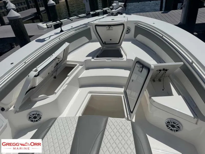 Slide: The Image of 2025 Regulator 30XO CROSSOVER boat interior with open storage compartments at dock. - 8