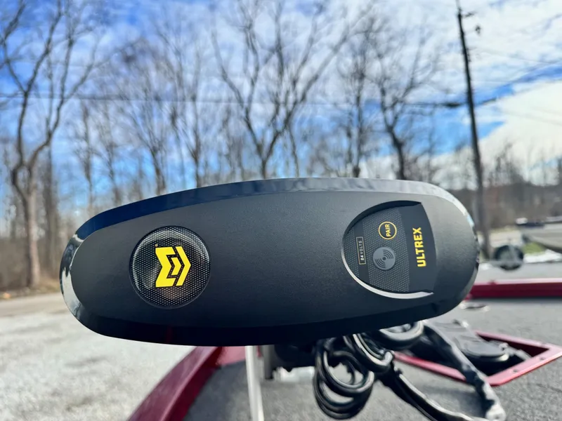 Slide: The Image of Close-up of Ultrex motor on 2025 Vexus AVX1985S boat, outdoors with trees in background. - 8