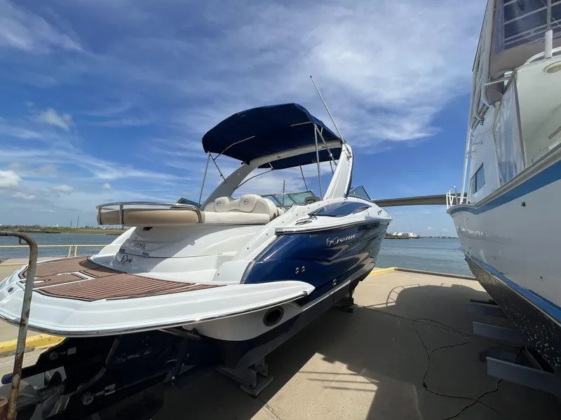 Slide: The Image of 2013 Crownline 325SS boat docked under a clear blue sky. - 3