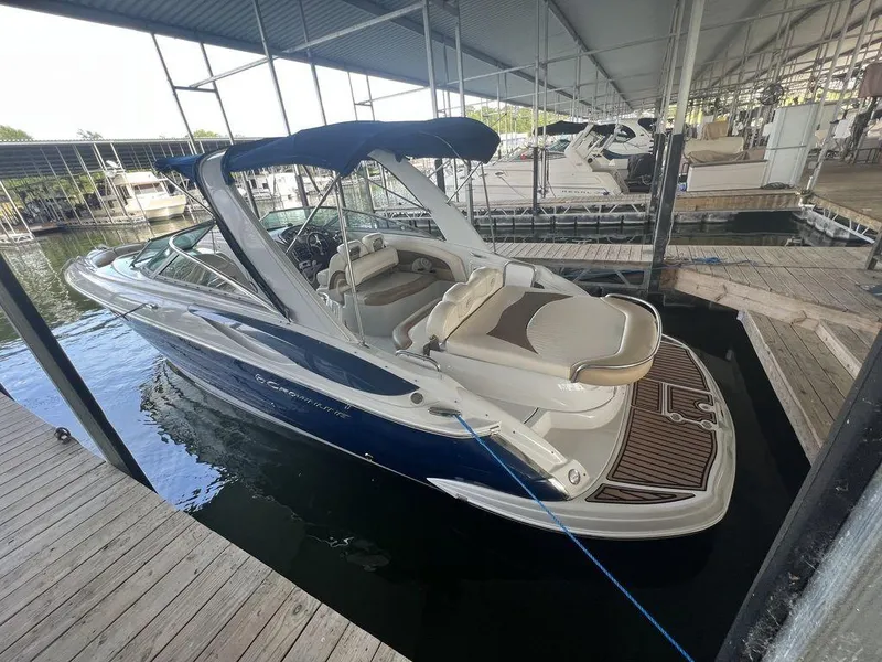 Slide: The Image of 2013 Crownline 325SS boat docked under covered marina. - 7