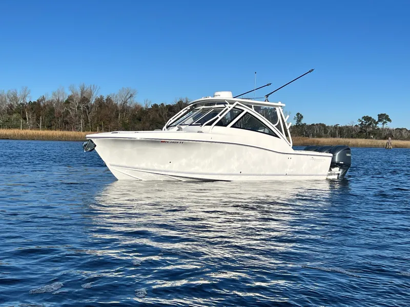 Slide: The Image of 2023 Albemarle 31 Dual Console boat on calm water under clear blue sky. - 11