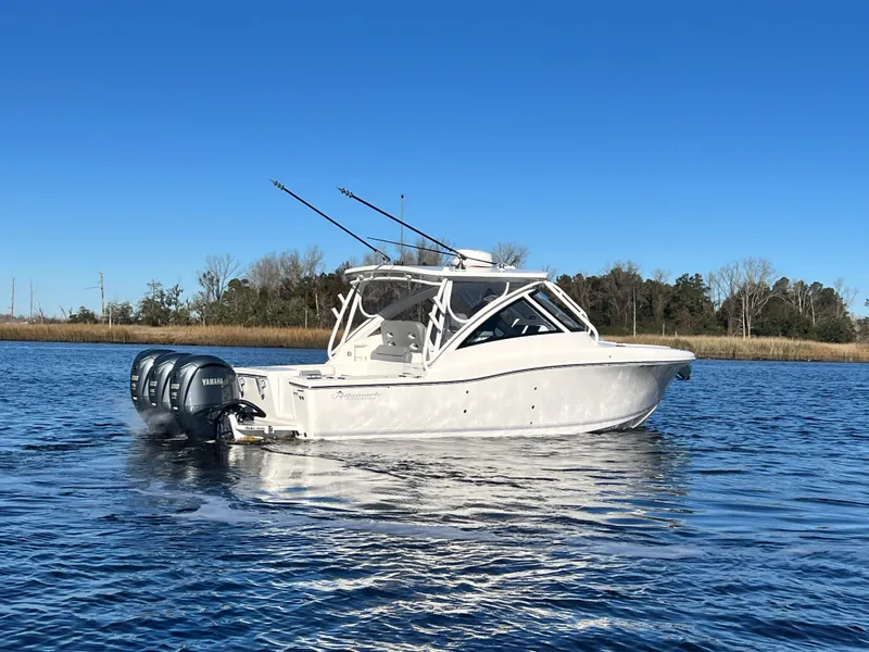 Slide: The Image of 2023 Albemarle 31 Dual Console boat on calm water with clear blue sky. - 3