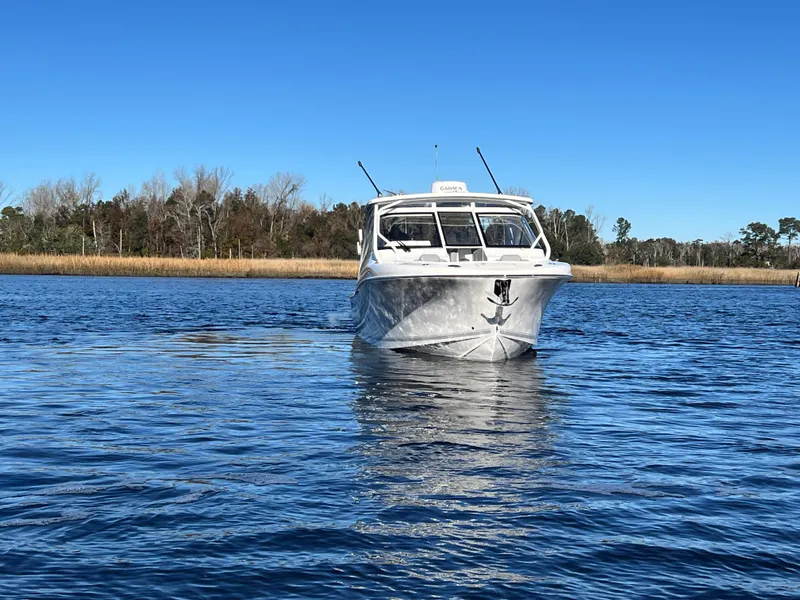 Slide: The Image of 2023 Albemarle 31 Dual Console boat cruising on a calm lake. - 7