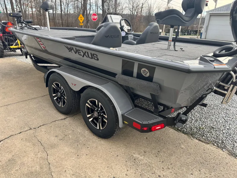 Slide: The Image of 2025 Vexus AVX1980 boat on trailer, gray exterior, dual axle, parked outdoors. - 13