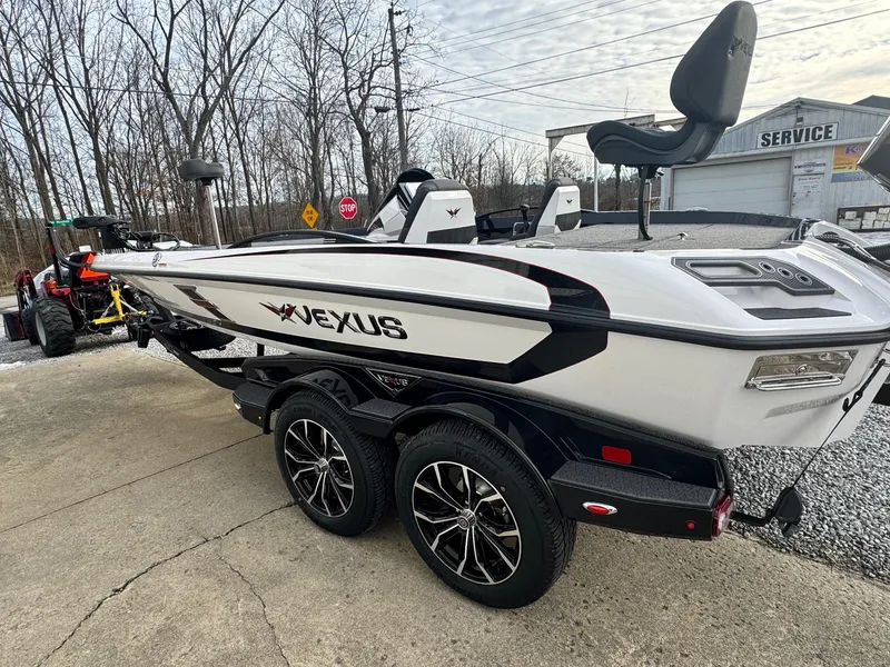 Slide: The Image of 2025 Vexus VXS21 boat on trailer, parked outdoors near service area. - 12