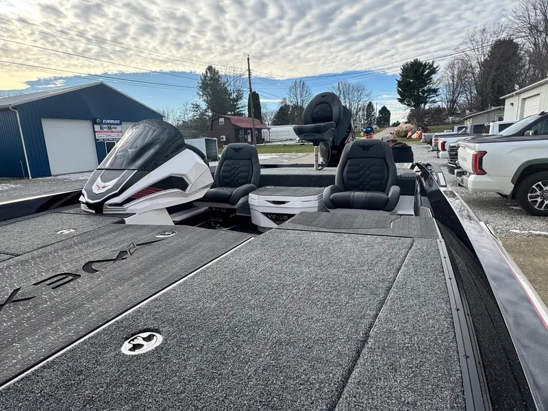 Slide: The Image of 2025 Vexus VXS21 boat with sleek design and comfortable seating, parked outdoors. - 9