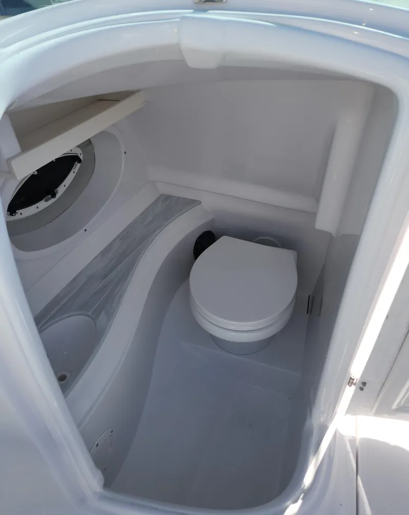 Slide: The Image of 2025 SouthWind 2400 SD boat interior with compact marine toilet. - 17