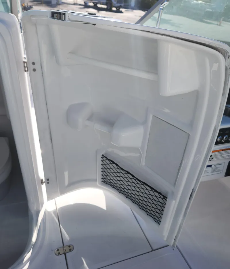 Slide: The Image of 2025 SouthWind 2400 SD boat interior storage compartment with netting. - 18