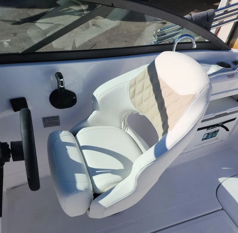 Slide: The Image of 2025 SouthWind 2400 SD boat interior with white captain's chair and steering wheel. - 9