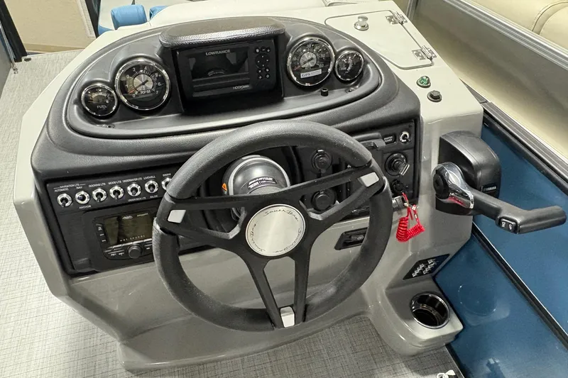 Slide: The Image of 2025 South Bay 200 boat dashboard with steering wheel, gauges, and control panel. - 8
