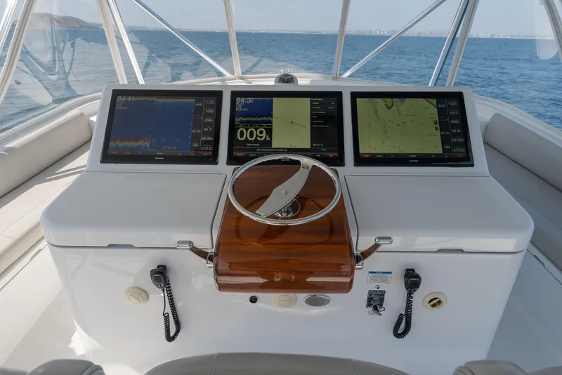 Slide: The Image of Helm of 2018 Hatteras GT70 yacht with navigation screens and steering wheel. - 11